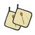 Wooden Spoon on Yellow Pair of Pot Holders