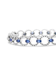 18K White Gold 6 Cttw Diamond and 5x3mm Oval Blue Sapphire Openwork Circle Link Bracelet (F-G Color, SI1-SI2 Clarity) - Size 7" - White Gold