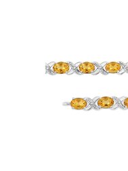 .925 Sterling Silver 7 x 5 Mm Oval Cut Orange Citrine And 1/20 Cttw Round Cut Diamond Fashion Tennis Bracelet