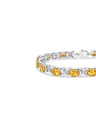 .925 Sterling Silver 7 x 5 Mm Oval Cut Orange Citrine And 1/20 Cttw Round Cut Diamond Fashion Tennis Bracelet - Sterling silver